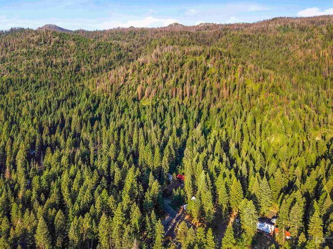 Aerial view of property and surrounding area featuring a mountainous background | Image 9