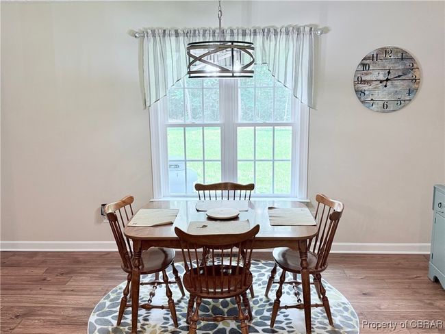 Dining area with wood finished floors, baseboards, and healthy amount of natural light | Image 4