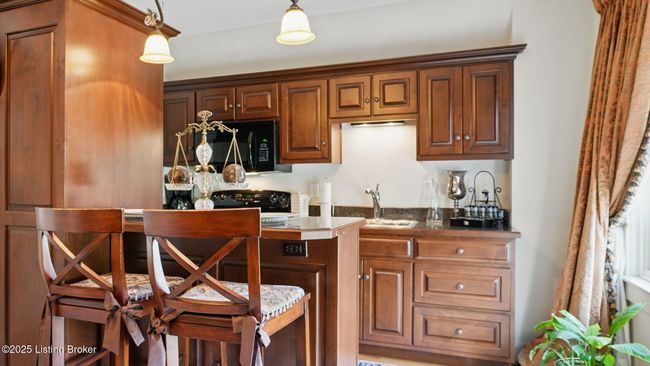 Full kitchen w/breakfast bar in 3rd floor guest suite. | Image 33