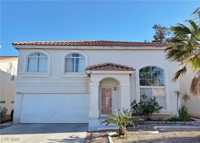 Mediterranean / spanish-style house featuring stucco siding, an attached garage, a tile roof, and driveway | Image 45
