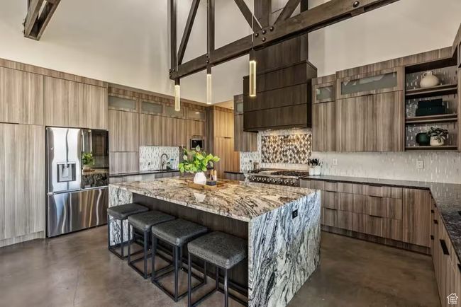 Kitchen featuring appliances with stainless steel finishes, modern cabinets, a kitchen island, and a breakfast bar | Image 4