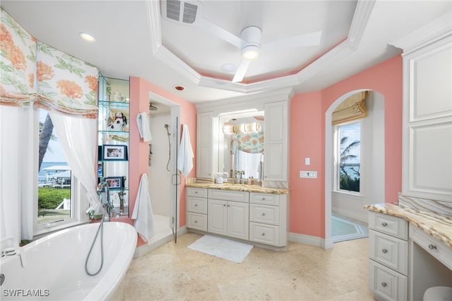 Primary bathroom his his/hers vanity areas, stand alone tub, shower and lovely ceiling features | Image 28