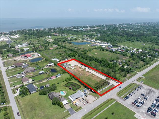 Aerial view of a spacious property outlined in red, with 8 residential lots and 8 more residential lots on the other side of the cul-de-sac, located in a semi-rural neighborhood with nearby homes and greenery. | Image 25