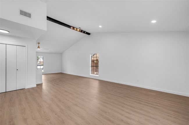 Unfurnished living room featuring light wood-type flooring, baseboards, a ceiling fan, and recessed lighting | Image 11