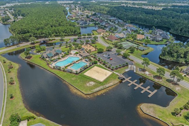 Aerial view of property and surrounding area featuring a nearby body of water and a pool | Image 39