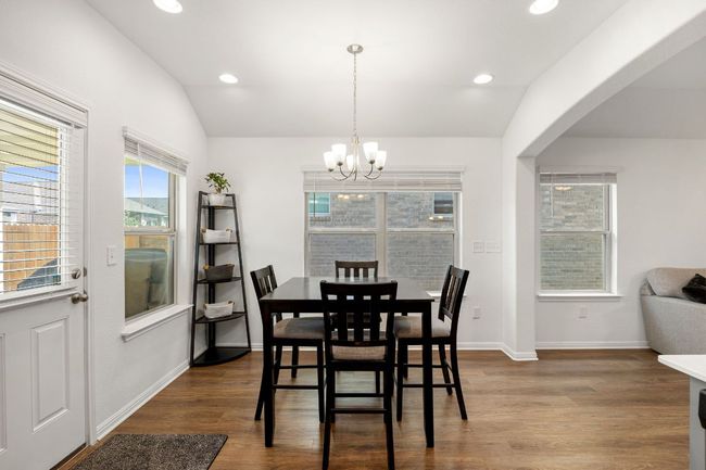 Dining area featuring a chandelier, dark wood-style floors, recessed lighting, and vaulted ceiling | Image 13