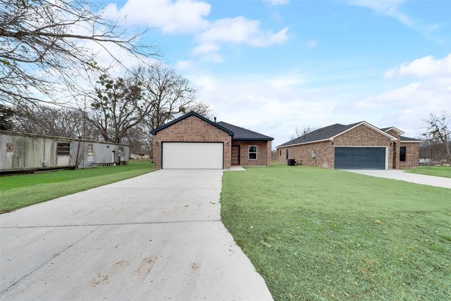 View of front of house featuring brick siding, driveway, and a front lawn | Image 31