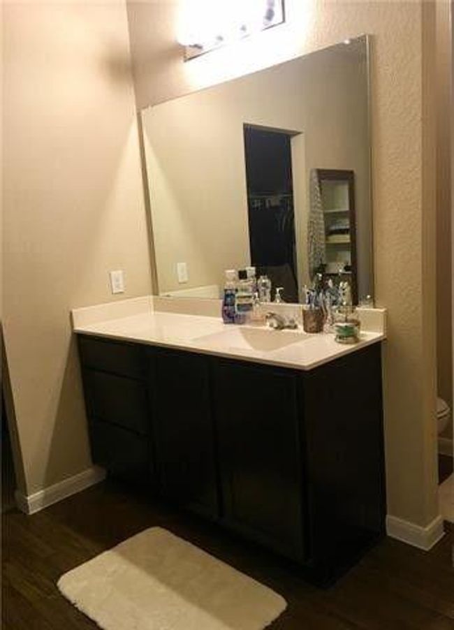 Bathroom featuring vanity, wood finished floors, baseboards, and toilet | Image 7