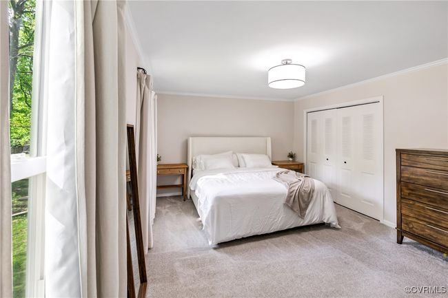 Carpeted bedroom featuring baseboards, ornamental molding, and a closet | Image 19