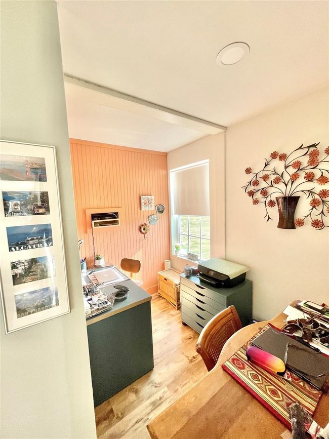 Bedroom featuring wood finished floors and an office area | Image 16