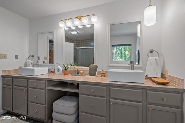 Updated light fixtures and freshly painted cabinetry. New hardware. New faucets to be installed. | Image 32