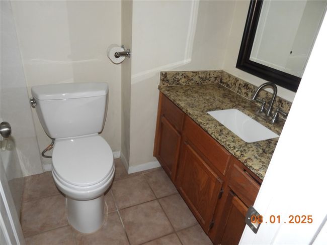 Bathroom with vanity and light tile patterned floors | Image 11