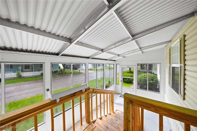 Enclosed patio space with tall windows | Image 4