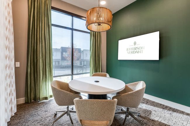 Dining space featuring a notable chandelier and carpet | Image 39