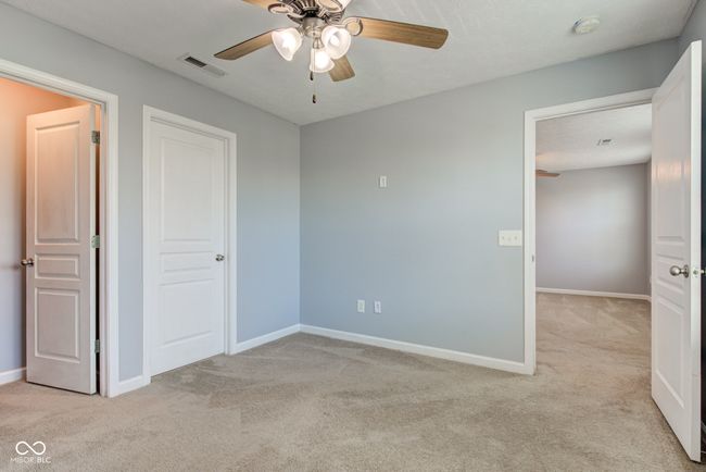 unfurnished bedroom featuring light colored carpet and ceiling fan | Image 44