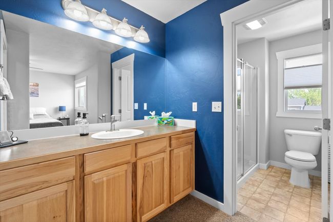 Full bathroom with a glass door stall shower, ensuite bathroom, and vanity | Image 19