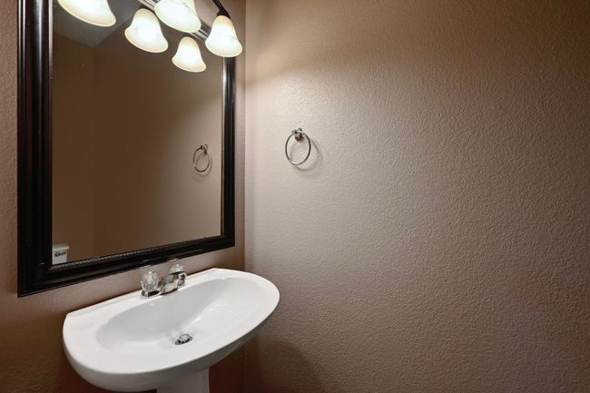 Downstairs half bathroom featuring a sink | Image 15