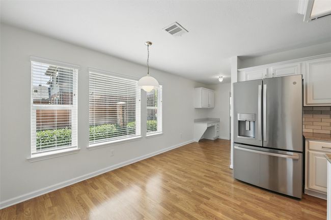 Follow the breakfast area around the corner and you will find a butler's pantry going into the formal or flex space. | Image 17