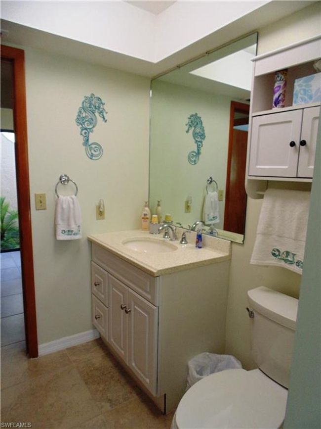 Half bath with toilet, tile patterned flooring, and vanity | Image 19