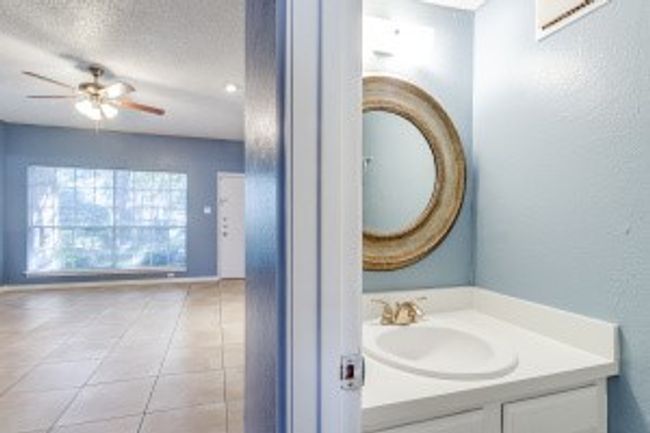 Bathroom with vanity, ceiling fan, a textured ceiling, and tile patterned floors | Image 12