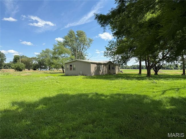 View of grassy yard with an outdoor structure and a view of countryside | Image 6