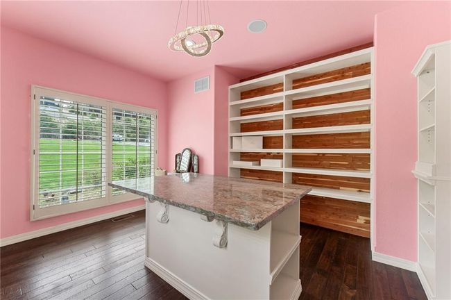 Spacious closet featuring visible vents, a chandelier, and dark wood-type flooring | Image 30