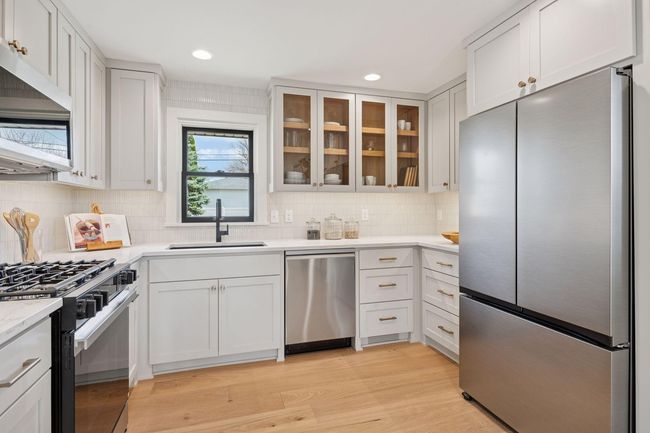 Completely updated kitchen offers upgrades not seen at this price point. Level 6 quartz, upgraded Samsung Appliances w/ gas range, under cabinet lighting and a stunning backsplash pulls everything together. | Image 9