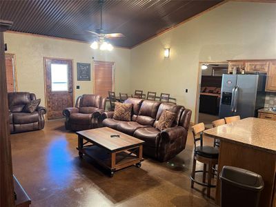 Living room featuring lofted ceiling, ornamental molding, and ceiling fan | Image 3