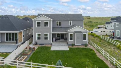 Large steps/patio pour out into your back yard. The yard and garden are meticulously maintained. You also have several fruit trees to take care of as well. | Image 3