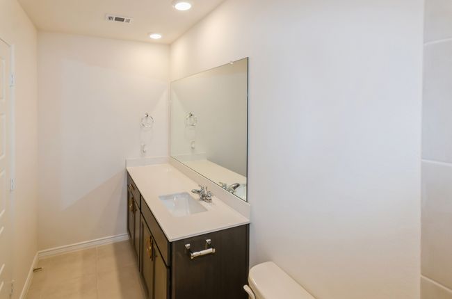 Bathroom featuring vanity, toilet, tile patterned floors, baseboards, and recessed lighting | Image 25