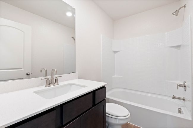 Bathroom with toilet, vanity, and shower / tub combination | Image 8