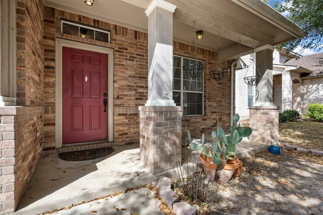 Entrance to property featuring brick siding and a porch | Image 6