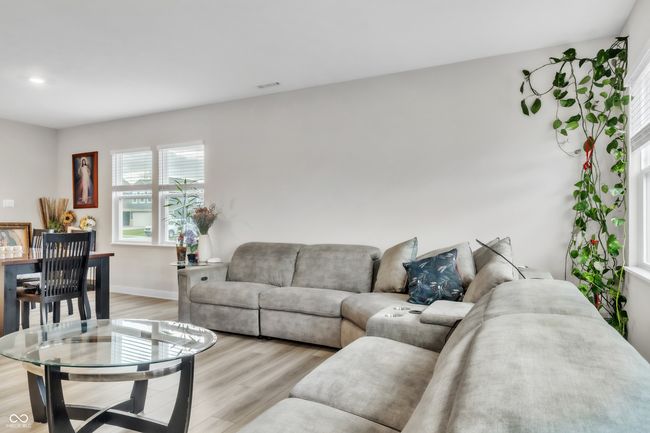 living area with visible vents, baseboards, recessed lighting, and light wood-style floors | Image 8