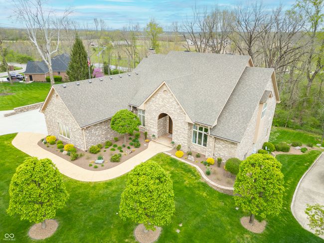 view of front of home with a shingled roof, a front lawn, and stone siding | Image 116