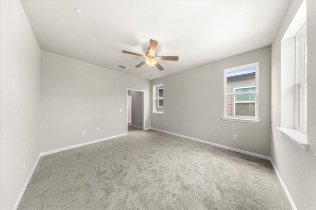 Unfurnished room with ceiling fan, plenty of natural light, and baseboards | Image 27