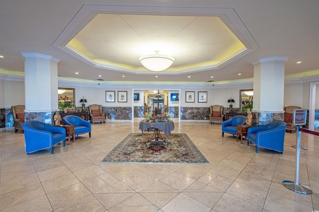 Carpeted office with recessed lighting, visible vents, baseboards, and wall of books | Image 22
