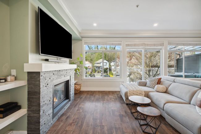 Living room featuring a fireplace, dark wood-type flooring, ornamental molding, recessed lighting, and baseboards | Image 4