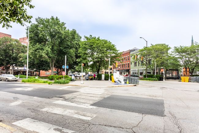 view of asphalt street with street lighting, curbs, traffic signs, and sidewalks | Image 39