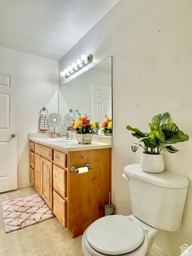 Half bath featuring vanity, tile patterned flooring, and toilet | Image 17