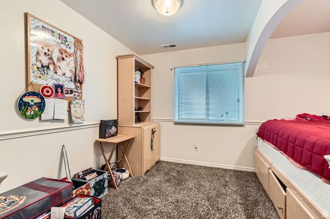 Bedroom with carpet and arched walkways | Image 24