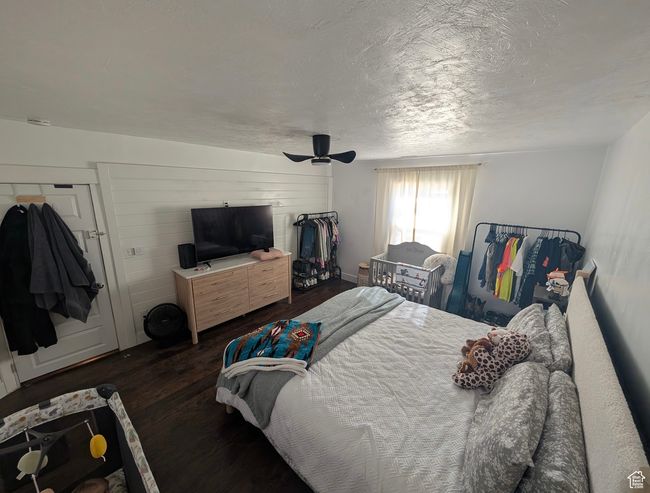 Bedroom with a textured ceiling, wood finished floors, and ceiling fan | Image 18
