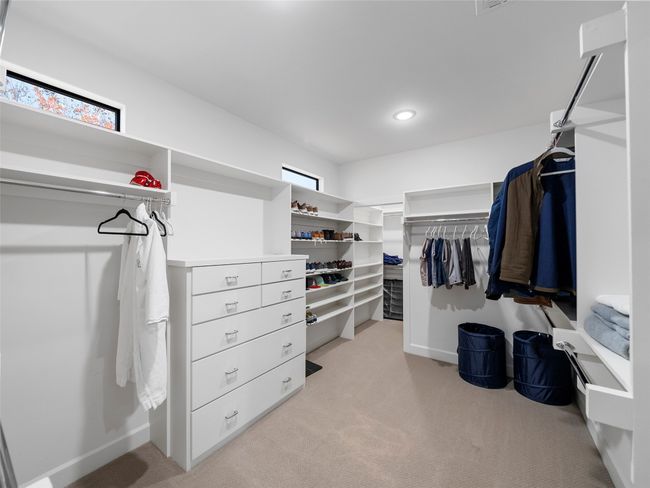Walk in closet featuring light colored carpet | Image 27