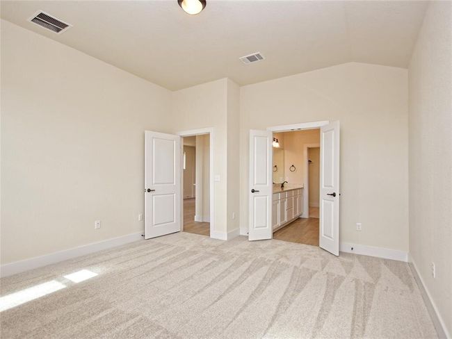 Unfurnished bedroom featuring vaulted ceiling and light colored carpet | Image 8
