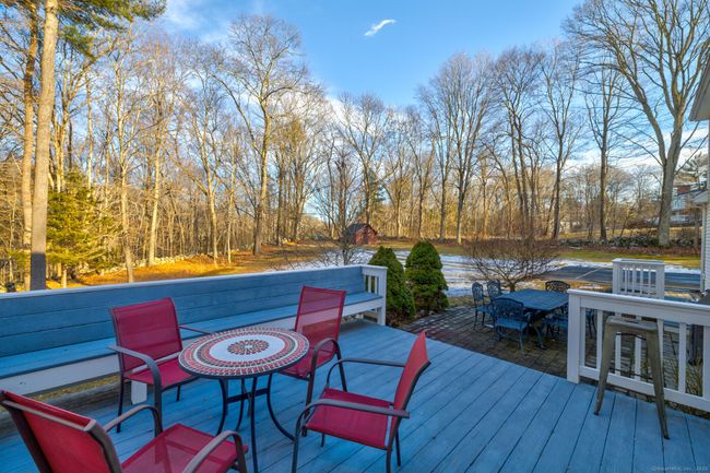 Large deck off the kitchen allows for easy indoor to outdoor entertaining. Built-in bench seating. | Image 29