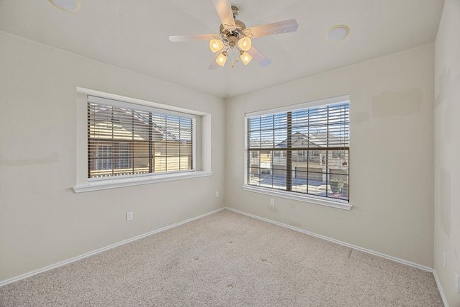 Carpeted spare room featuring baseboards and a ceiling fan | Image 24