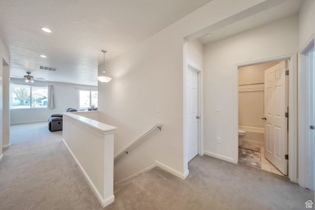 Hall with recessed lighting, visible vents, an upstairs landing, baseboards, and carpet flooring | Image 10
