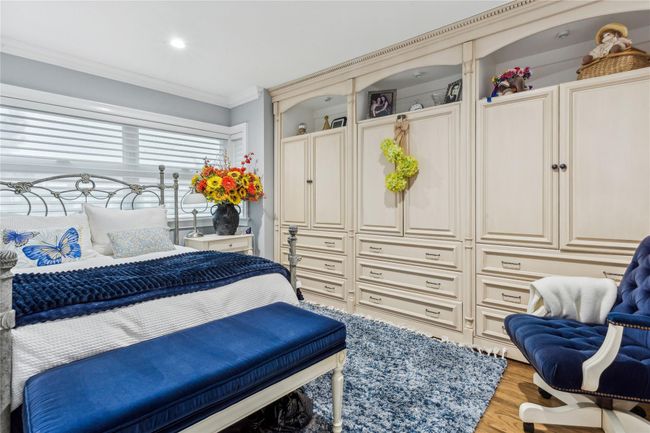 Bedroom with ornamental molding and light wood-type flooring | Image 12