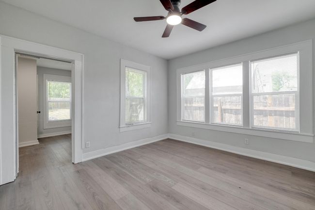 Unfurnished room with a ceiling fan and light wood-style floors | Image 35