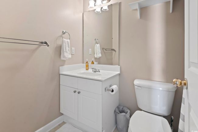 Half bath featuring toilet, vanity, and baseboards | Image 28