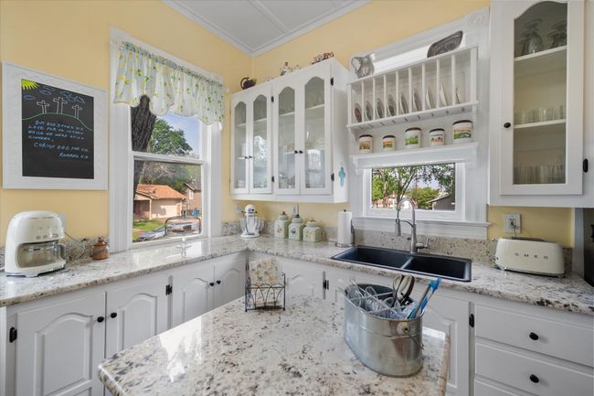 Kitchen with a sink, white cabinets, healthy amount of natural light, and crown molding | Image 15